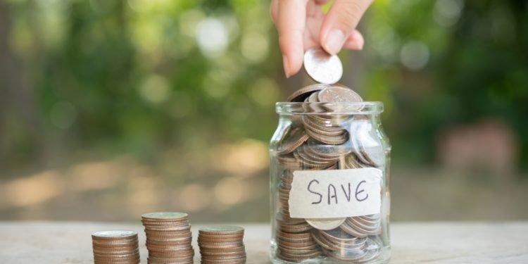 saving-money-concept-preset-by-male-hand-putting-money-coin-stack-growing-business-arrange-coins-into-heaps-with-hands-content-about-money - Pratama Institute