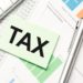 tax-concept-word-tax-calculator-with-tax-forms-money - Pratama Institute Jalan Terjal Bea Materai E-Commerce