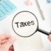 magnifying-glass-word-tax-form-1040 - Pratama Institute Mendapatkan Surat Tagihan Pajak (STP) yang Tidak Benar dari KPP, Bagaimana Solusinya ya?