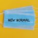 new-normal-text-surgical-face-mask-yellow-background-covid19-concept - Pratama Institute COVID-19 Pandemic Challenges for MSMEs: Strategic Options for Surviving in the New Normal Era