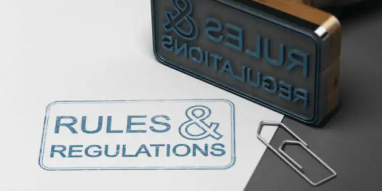 3d-illustration-rubber-stamp-with-other-office-supplies-text-rules-regulations-sheet-paper - Pratama Institute Omnibus Law dan Pencegahan Korupsi