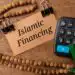top-view-prayer-beadcalculator-brown-card-with-text-islamic-financing-wooden-background - Pratama Institute Syariah