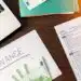 table-with-finance-work-stuff-laptop-money-pen-papers - Pratama Institute pandemi
