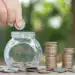 Saving money concept preset by Male hand putting money coin stac - Pratama Institute deposit