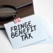 magnifying-glass-with-fringe-benefit-tax-sign-paper-sheet - Pratama Institute pajak natura