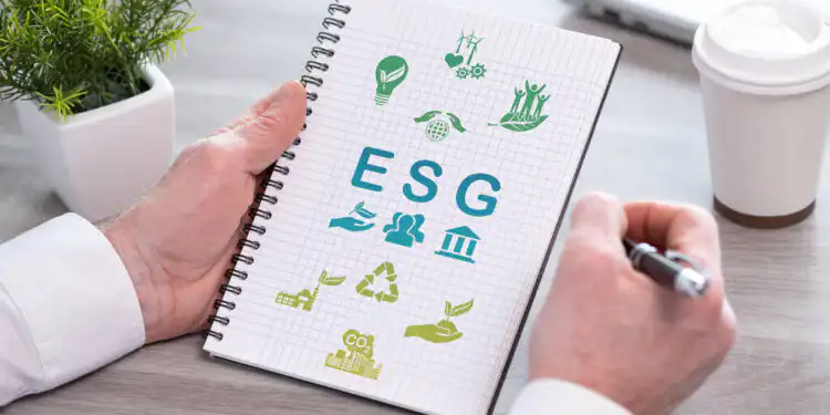 Esg concept on a notepad - Pratama Institute Hand holding a notepad with esg concept