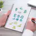 Hand holding a notepad with esg concept