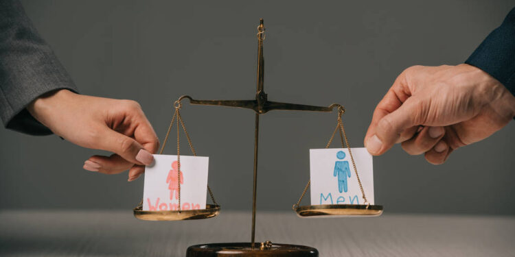 stock-photo-cropped-view-businesspeople-male-female-signs-scales-justice-gender-equality - Pratama Institute Mengapa Keberagaman Gender di Dewan Direksi Penting untuk ESG?
