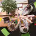 Business people showing teamwork in office - Pratama Institute Group of five colleagues around a table joining hands in a teamwork gesture, viewed from above.
