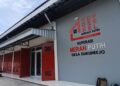 Exterior of a cooperative building with red doors and a large sign reading Koperasi Merah Putih Desa Dukuhrejo