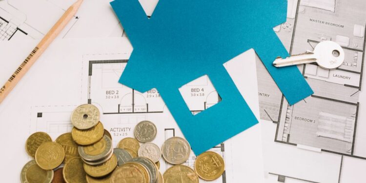 - Pratama Institute Blue house cutout on floor plans with coins, a key, pencil, and ruler—evoking home financing or real estate budgeting.