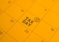 Calendar page highlighting TAX DAY on the 15th with a circled 15 mark in a yellow page theme.